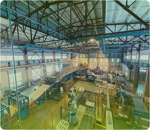 Interior of a large factory with industrial equipment and workstations